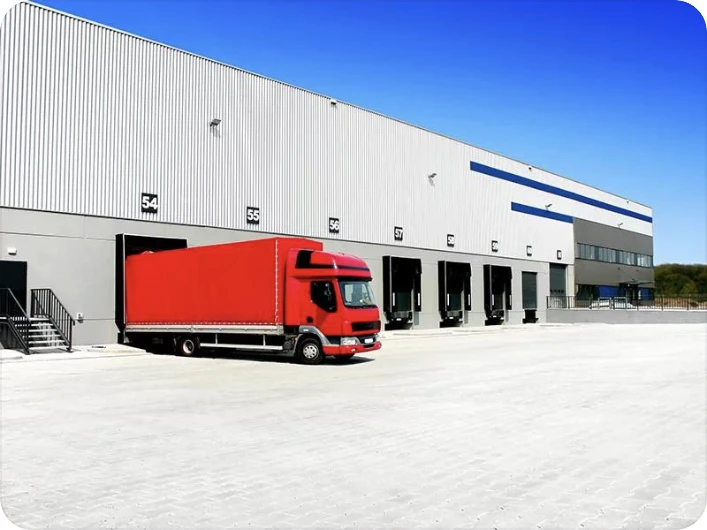 Cold-storage loading docks with a red refrigerated truck — user-provided reference image.